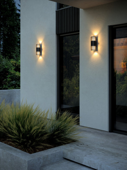 Nordlux Aludra double outdoor wall light mounted on a wall, casting light up and down