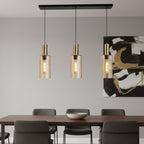 Arden Smoked Amber Glass 3 Light Bar Pendant hanging above a dining table in a modern room