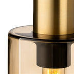 Close-up detail of the Arden pendant showing the satin brass stem meeting the smoked amber glass shade