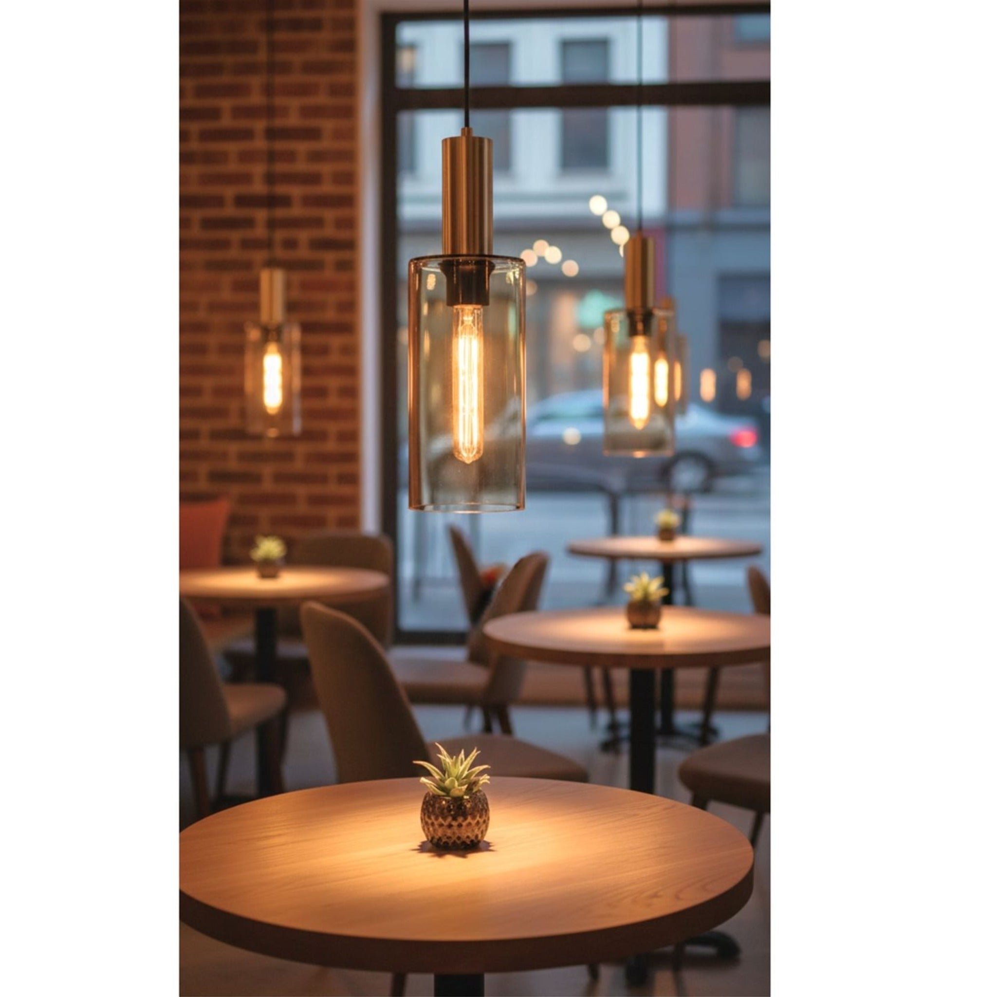 Arden Smoked Amber Glass Pendants hung in a row above cafe tables