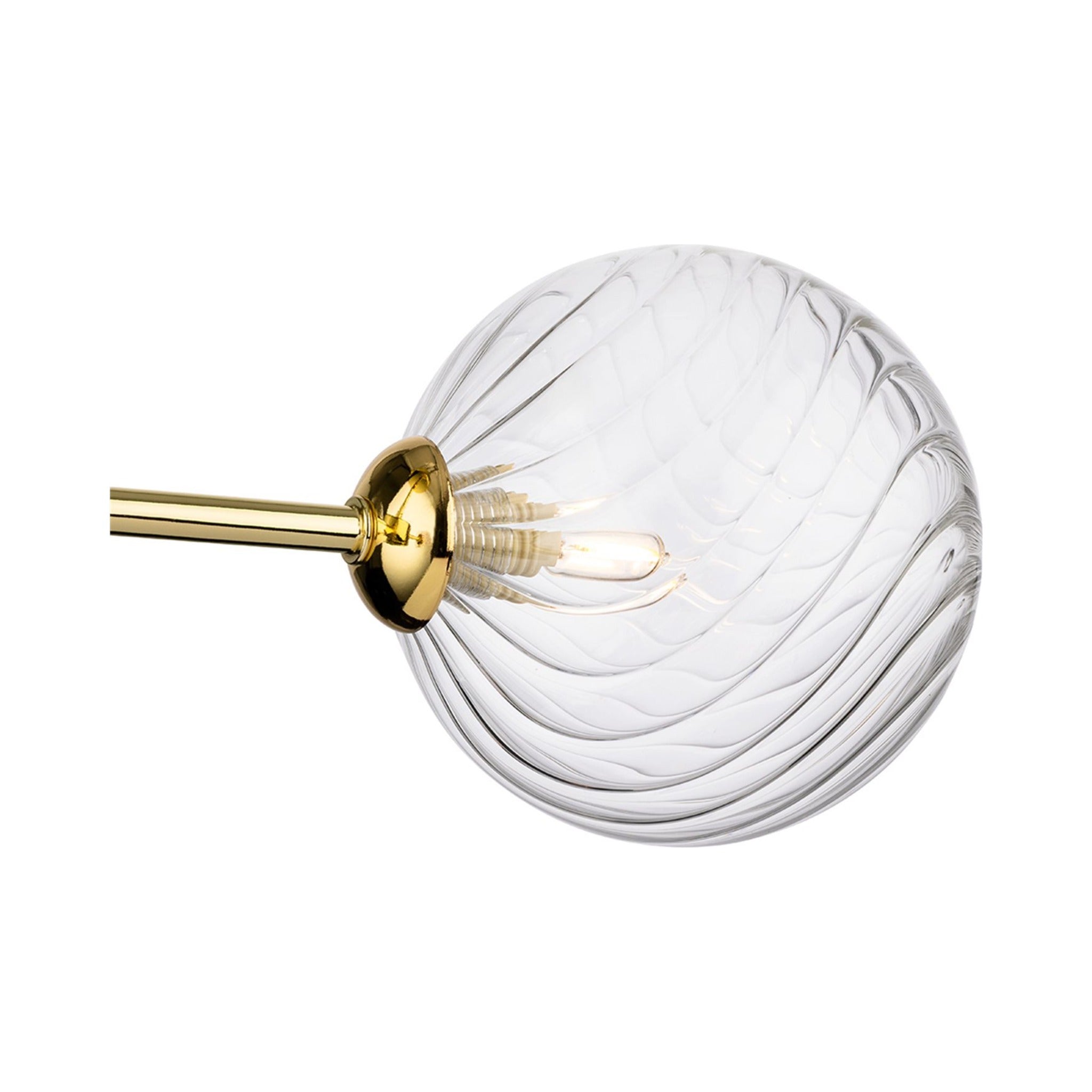 Close-up of the swirled clear glass globe and brass arm on the Ashby Semi-Flush Ceiling Light