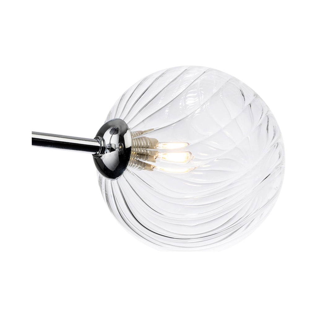 Close-up of the swirled clear glass globe and chrome arm on the Ashby Semi-Flush Ceiling Light