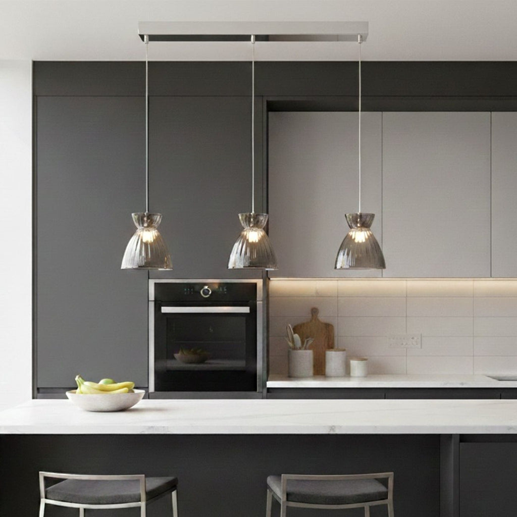 Bexley 3 Light Bar Pendant in smoked glass hung over a kitchen island