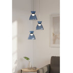 Bexley 3 Light Cluster Pendant in blue glass hung in a living room corner