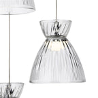 Clear fluted glass shade of the Bexley 3 Light Cluster Pendant, lit, with the chrome rose above