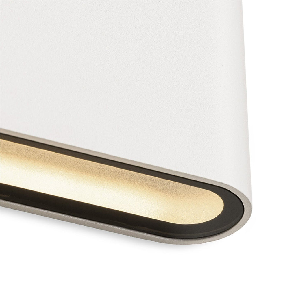 Close-up of the lit lower edge of the Brecon Slim LED Up & Down Wall Light in white