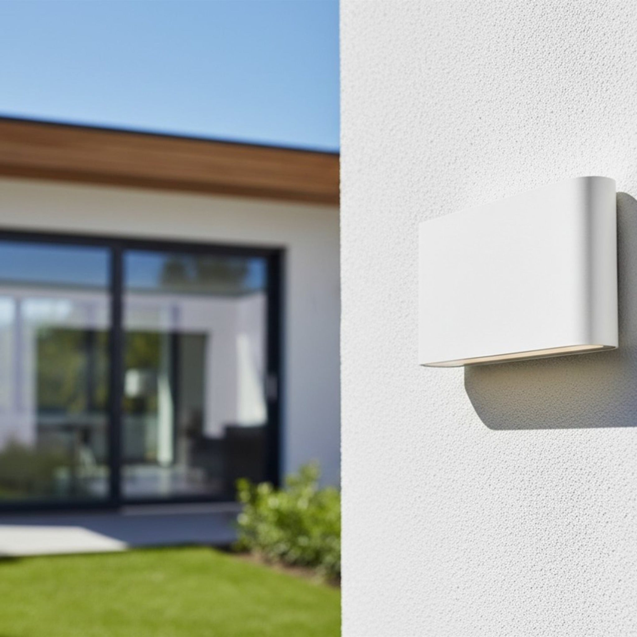 Brecon Slim LED Up & Down Wall Light in white mounted on an exterior house wall
