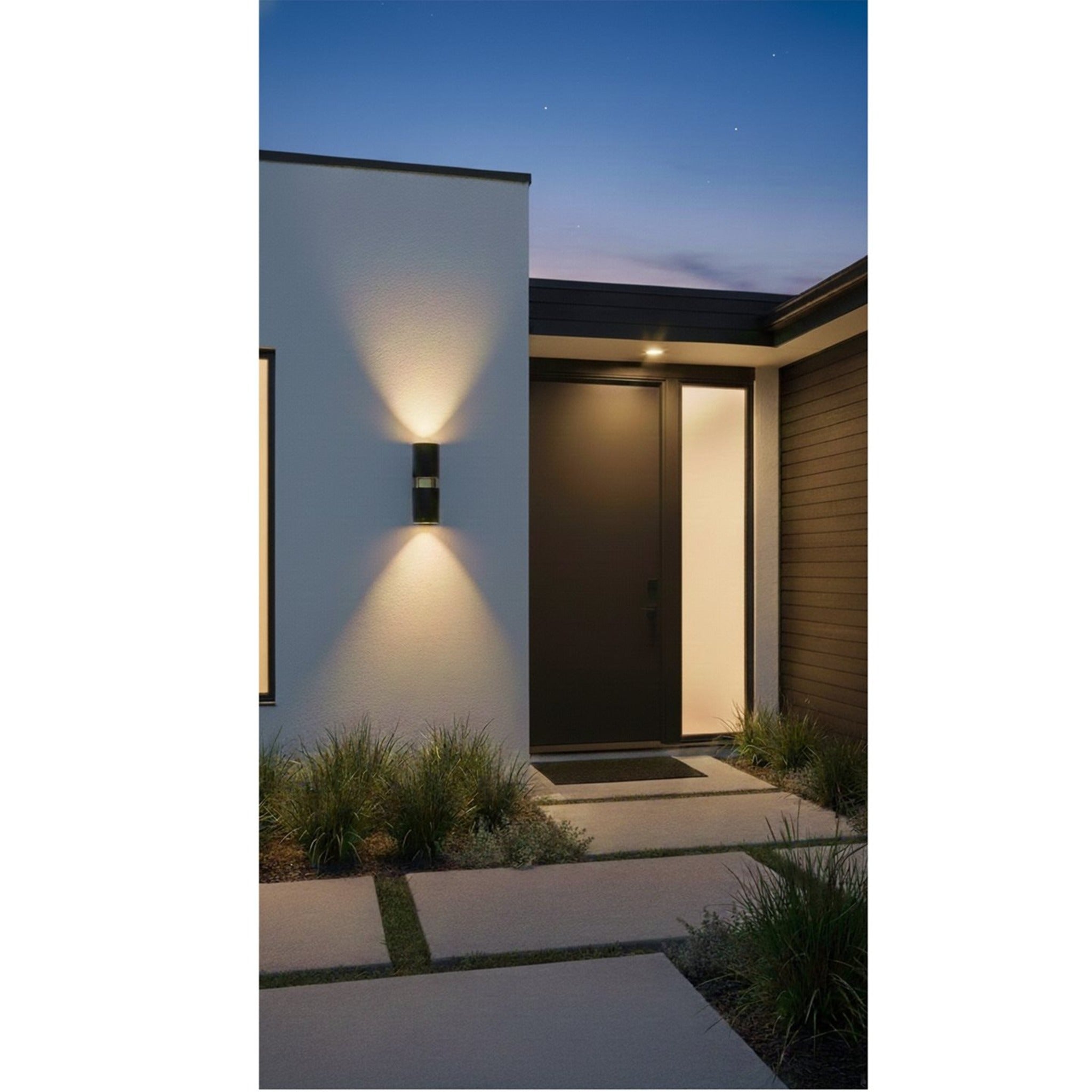 Denby Slim Up & Down Wall Light in black lit at dusk on a house exterior