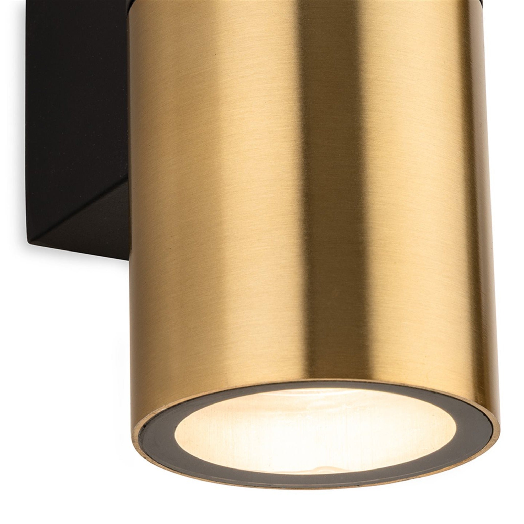Close-up detail of the Denby Slim Up & Down Wall Light in brushed brass, showing the lit cylinder