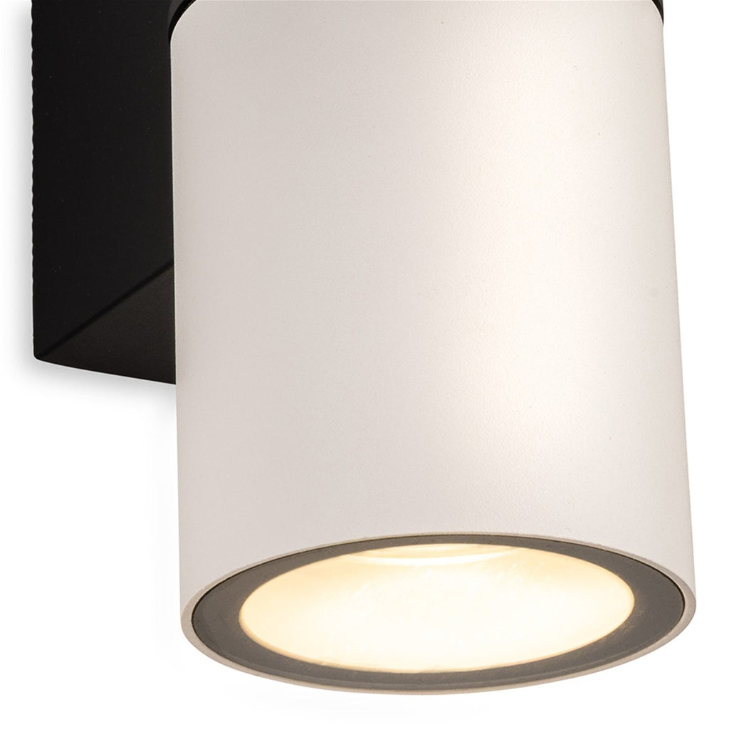 Close-up detail of the Denby Slim Up & Down Wall Light in white, showing the lit lower cylinder