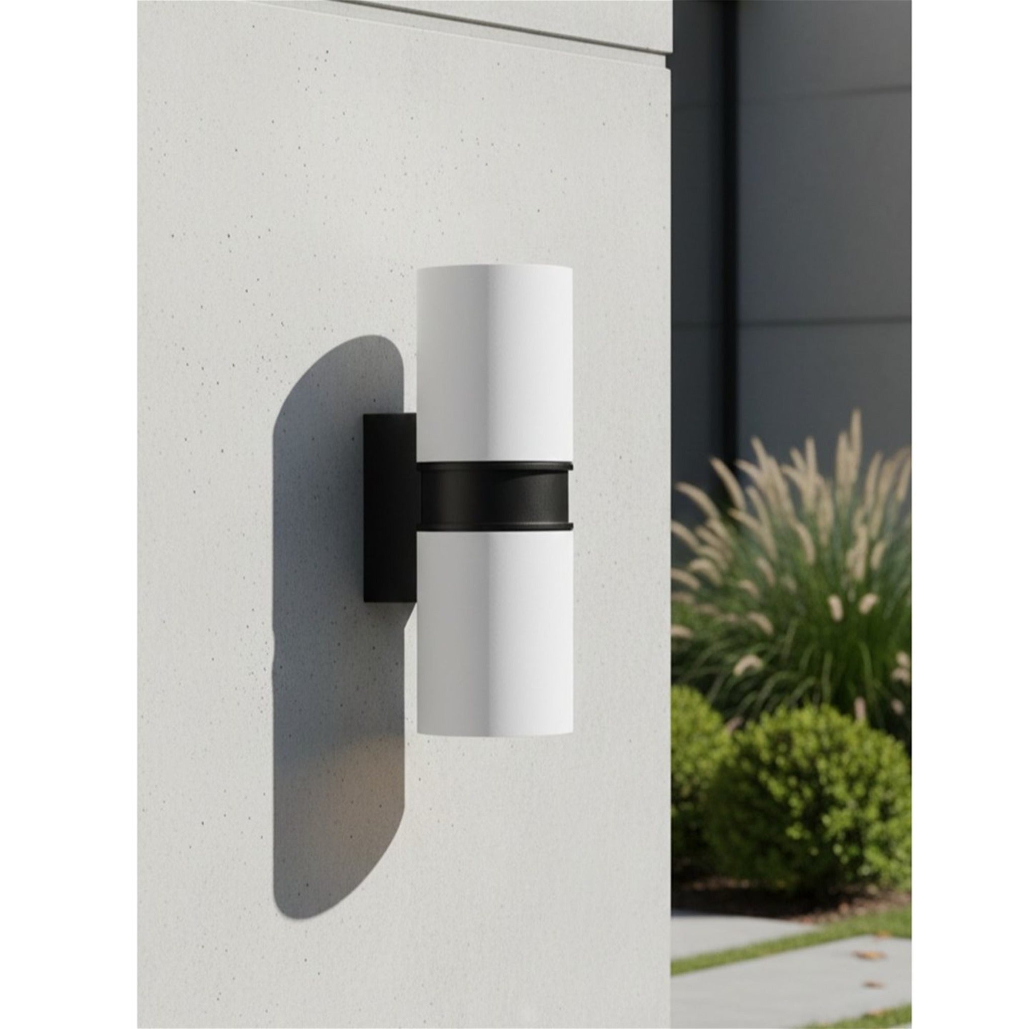 Denby Slim Up & Down Wall Light in white mounted on a rendered garden wall