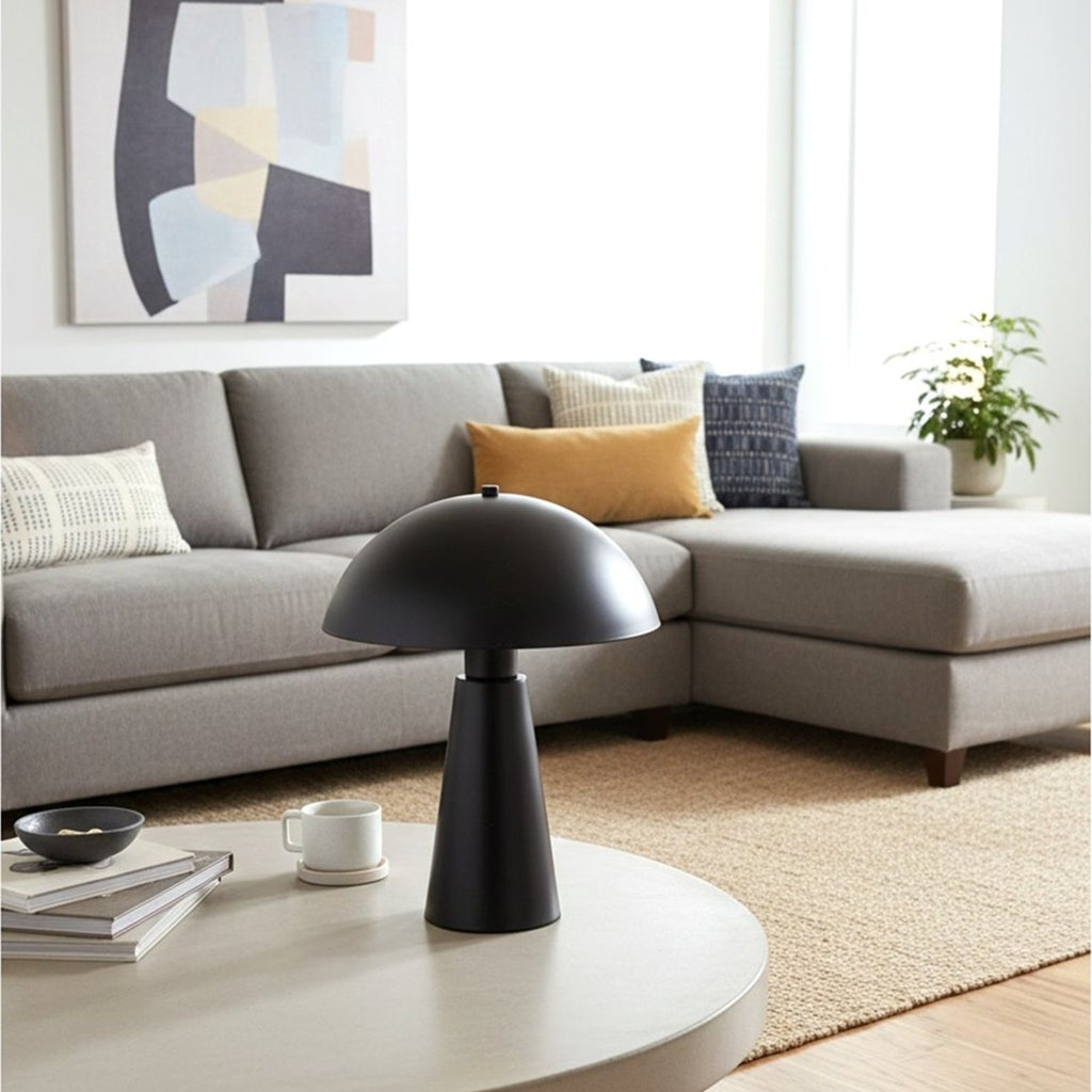 Halden Dome Table Lamp in satin black on a round living room coffee table