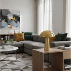 Halden Dome Table Lamp in brushed brass on a living room side table