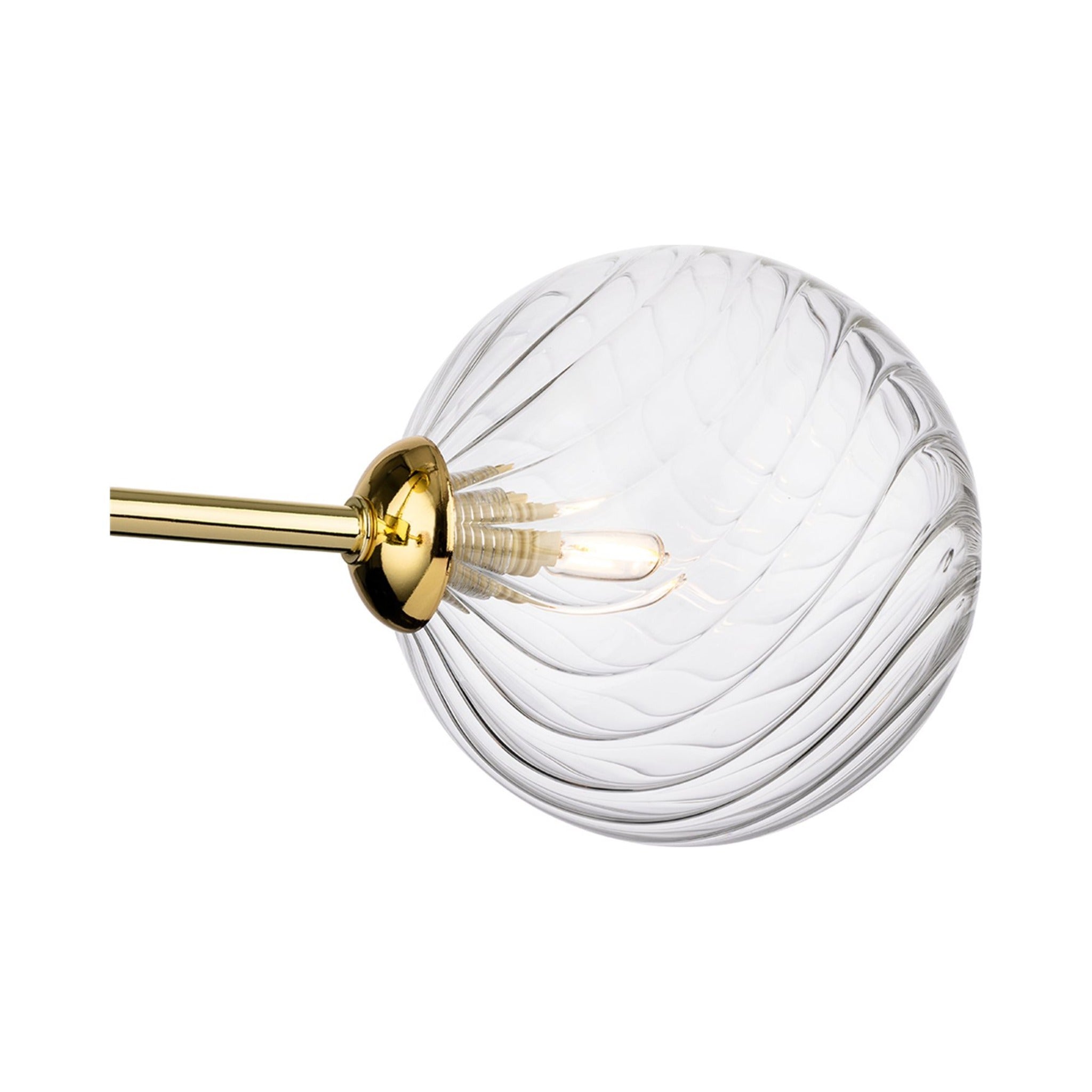 Close-up of the swirled clear glass globe and brass fitting