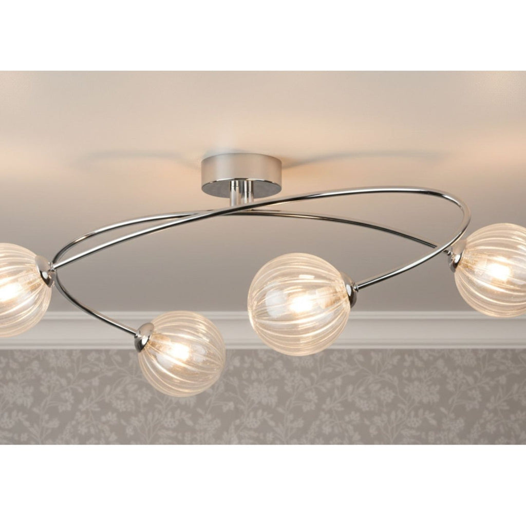 Linden Swirled Glass 4 Light Flush Ceiling Light in chrome, lit on a living room ceiling