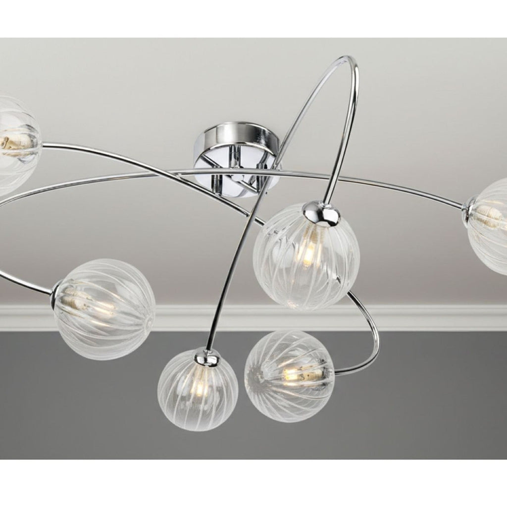 Linden Swirled Glass 6 Light Flush Ceiling Light in chrome, lit on a living room ceiling