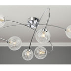 Linden Swirled Glass 6 Light Flush Ceiling Light in chrome, lit on a living room ceiling
