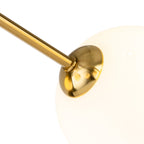 Close-up of an opal white glass globe on a brushed brass arm of the Lyra 6 Globe Flush Ceiling Light