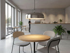 Marlow Wide Dome Pendant in brushed steel hanging over a dining table in a bright open room
