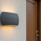 Nairn wall light in graphite lit beside a front door