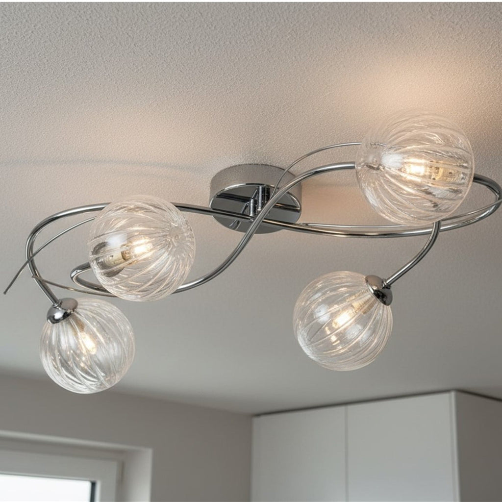 Orla Swirl Globe 4 Light Flush Ceiling Light in chrome lit on a room ceiling