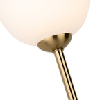 Close-up of an opal white glass globe on its brushed brass arm