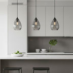 Three Orla Teardrop Glass Pendants in smoked glass hanging over a kitchen island
