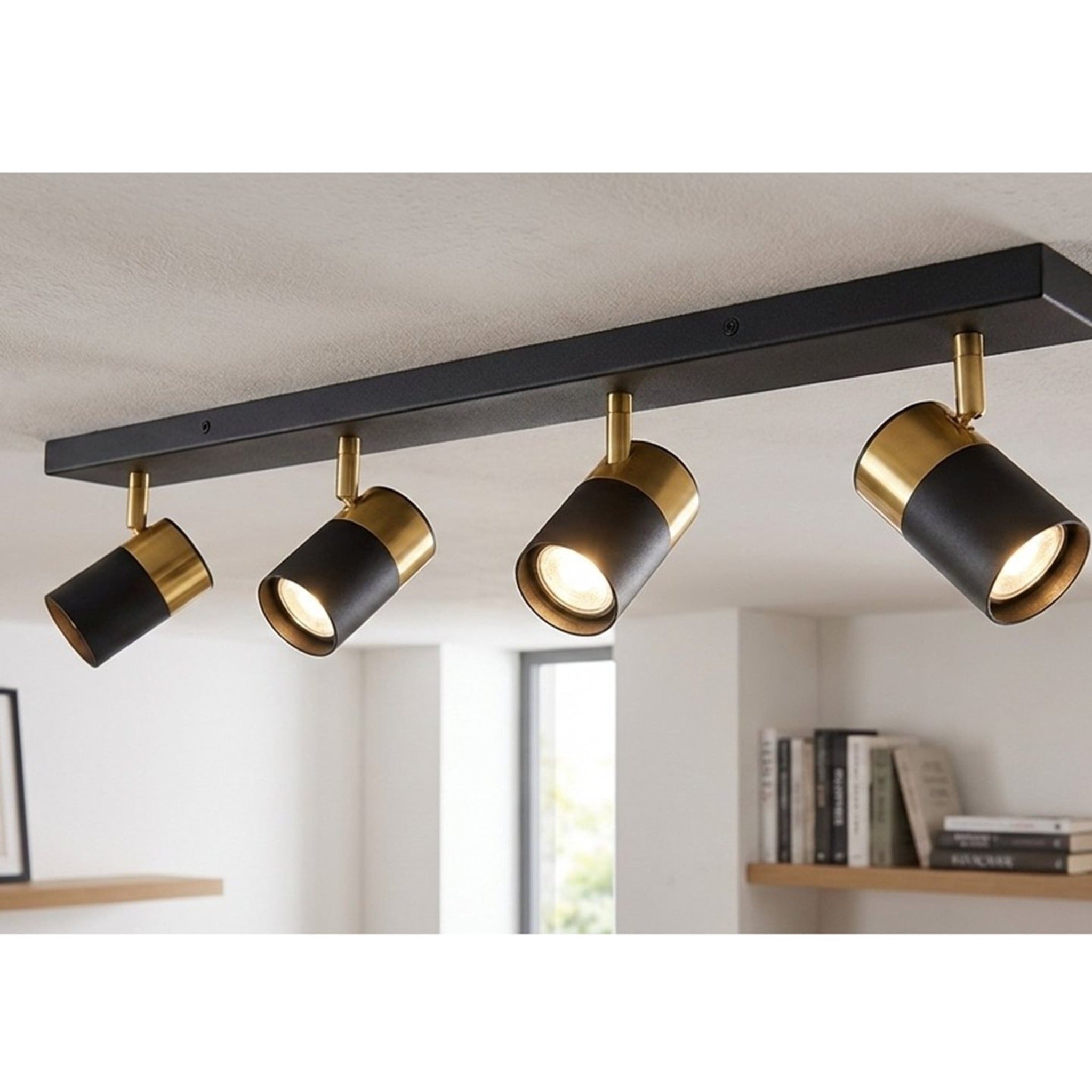 Renn 4 Light GU10 Ceiling Spotlight Bar in black with brushed brass mounted on a ceiling above a living space