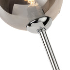 Close-up of the smoked glass shade and fluted chrome stem