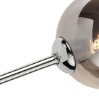 Close-up of a smoked glass shade on its chrome arm