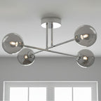 Ripley Glass Globe 4 Light Semi-Flush Ceiling Light in chrome, lit on a living room ceiling