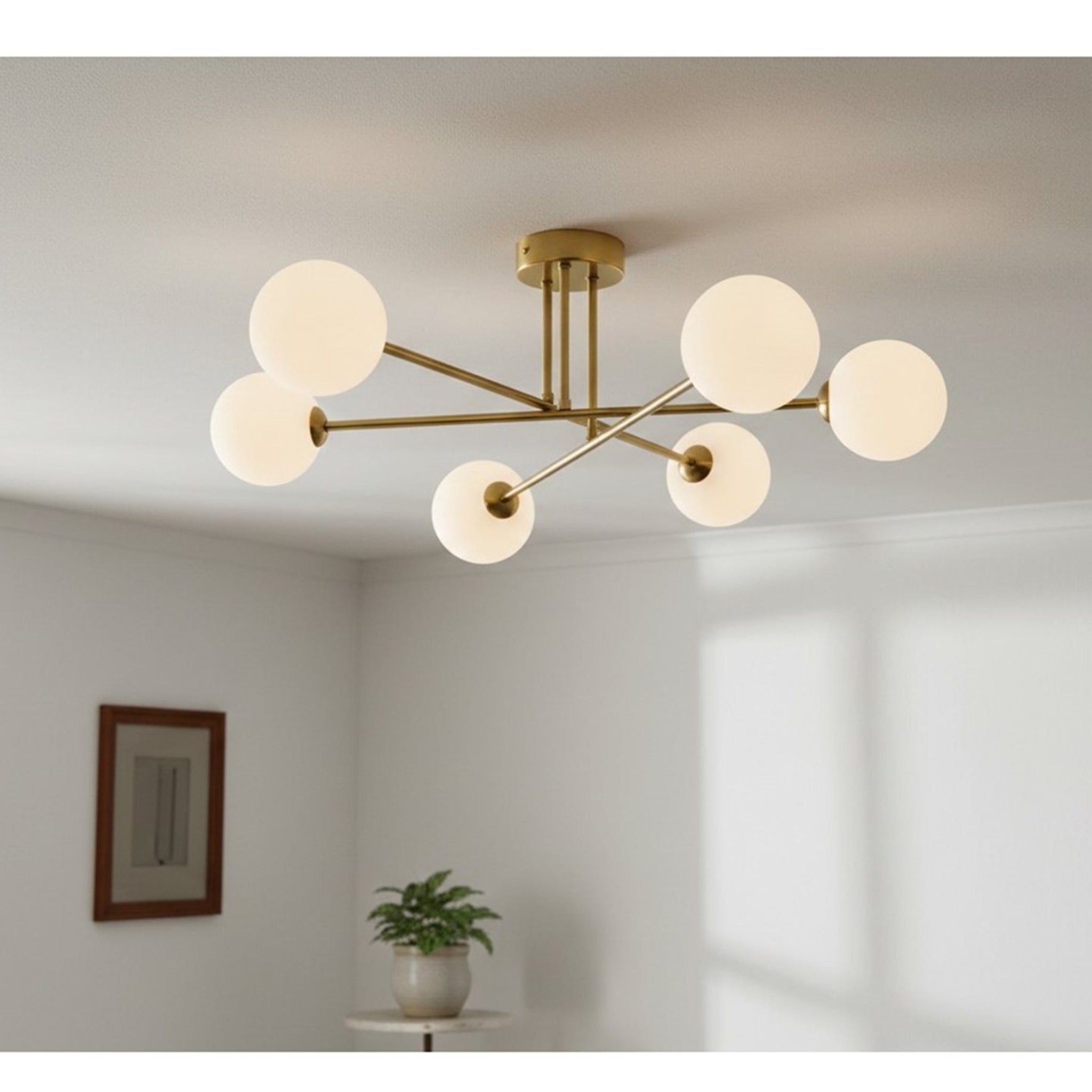 Ripley Glass Globe 6 Light Semi-Flush Ceiling Light in brushed brass, lit on a living room ceiling
