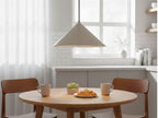 Rowan Conical Pendant in brushed steel hanging above a round kitchen table