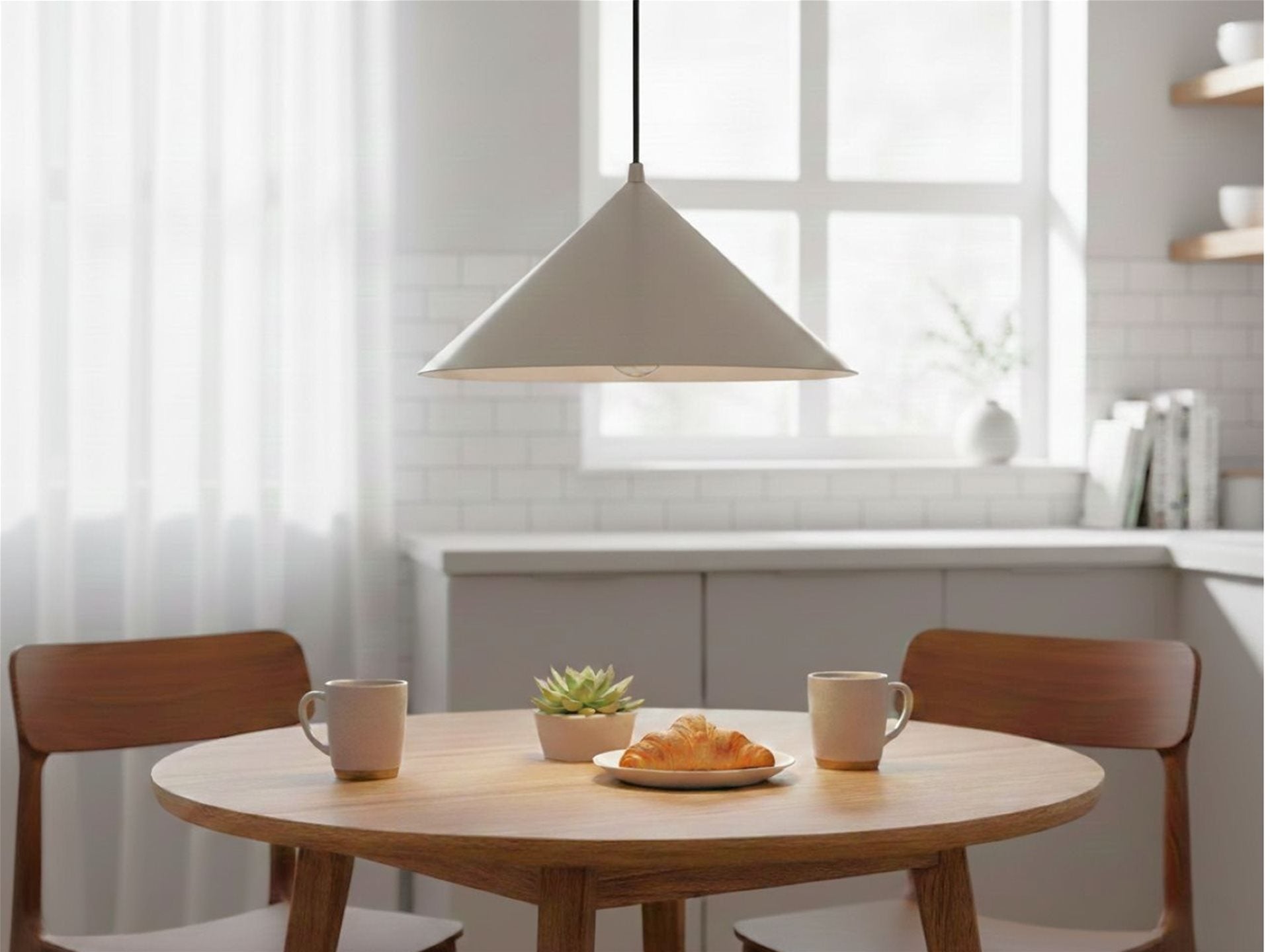 Rowan Conical Pendant in brushed steel hanging above a round kitchen table