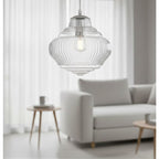 Selby Fluted Glass Pendant in chrome hanging in a living room beside a sofa and side table