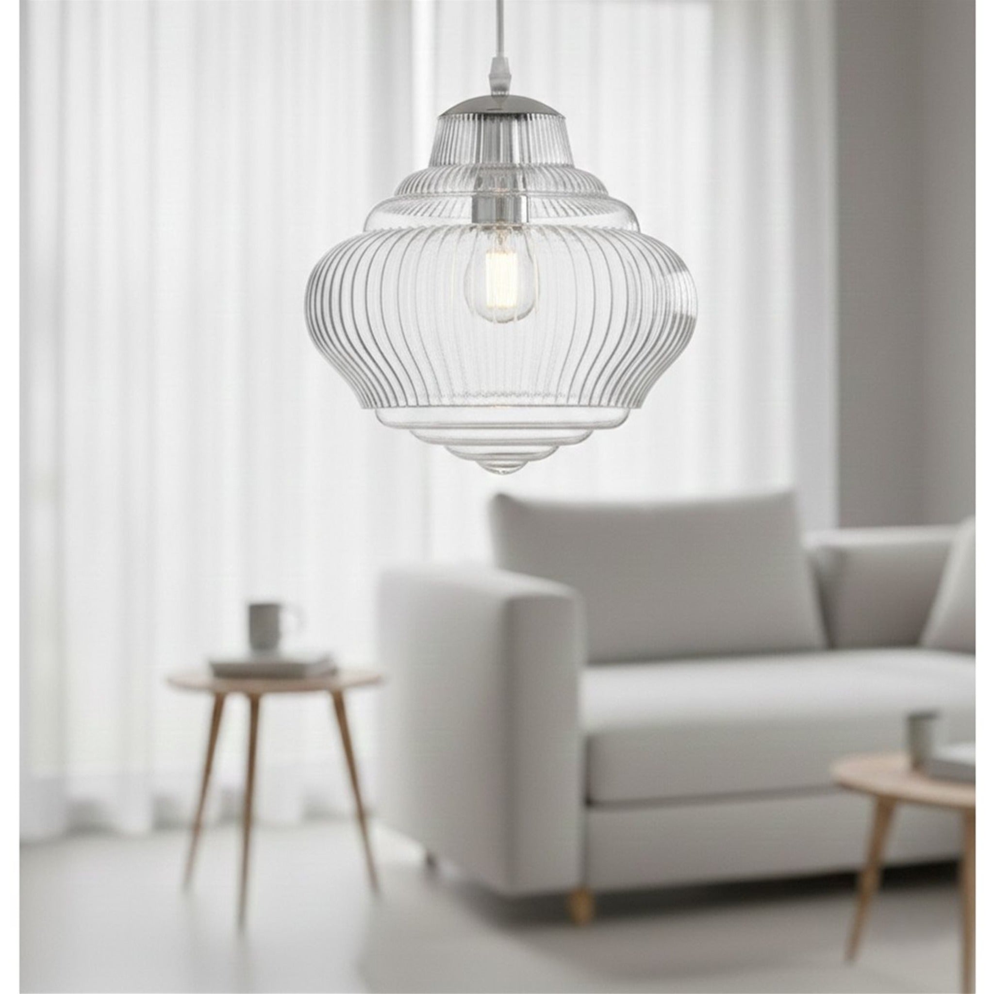 Selby Fluted Glass Pendant in chrome hanging in a living room beside a sofa and side table
