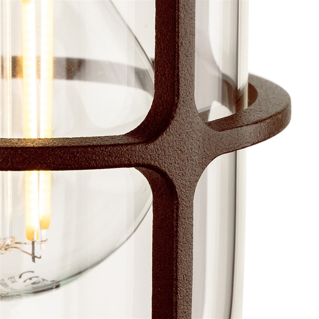 Close-up of the textured rustic brown cage and clear glass on the Tarbet Caged Glass Outdoor Wall Light